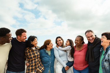 A group of people stand outside smiling