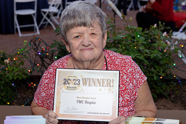 Hospice supporter Dorothy Lietha showing TMC Hospice 2023 Reader's Choice certificate 